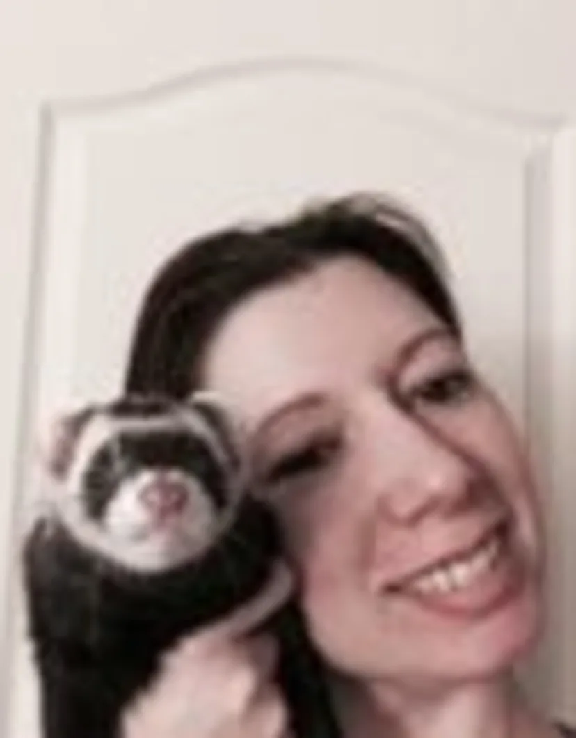 Barbara Krecko's staff photo from Shinnecock Animal Hospital where she is holding a black and white ferret.